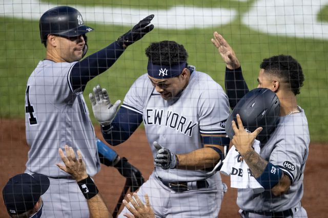 A photo of Yankees Gary Sanchez and Gleyber Torres celebrating with Giancarlo Stanton during the 2020 opening weekend